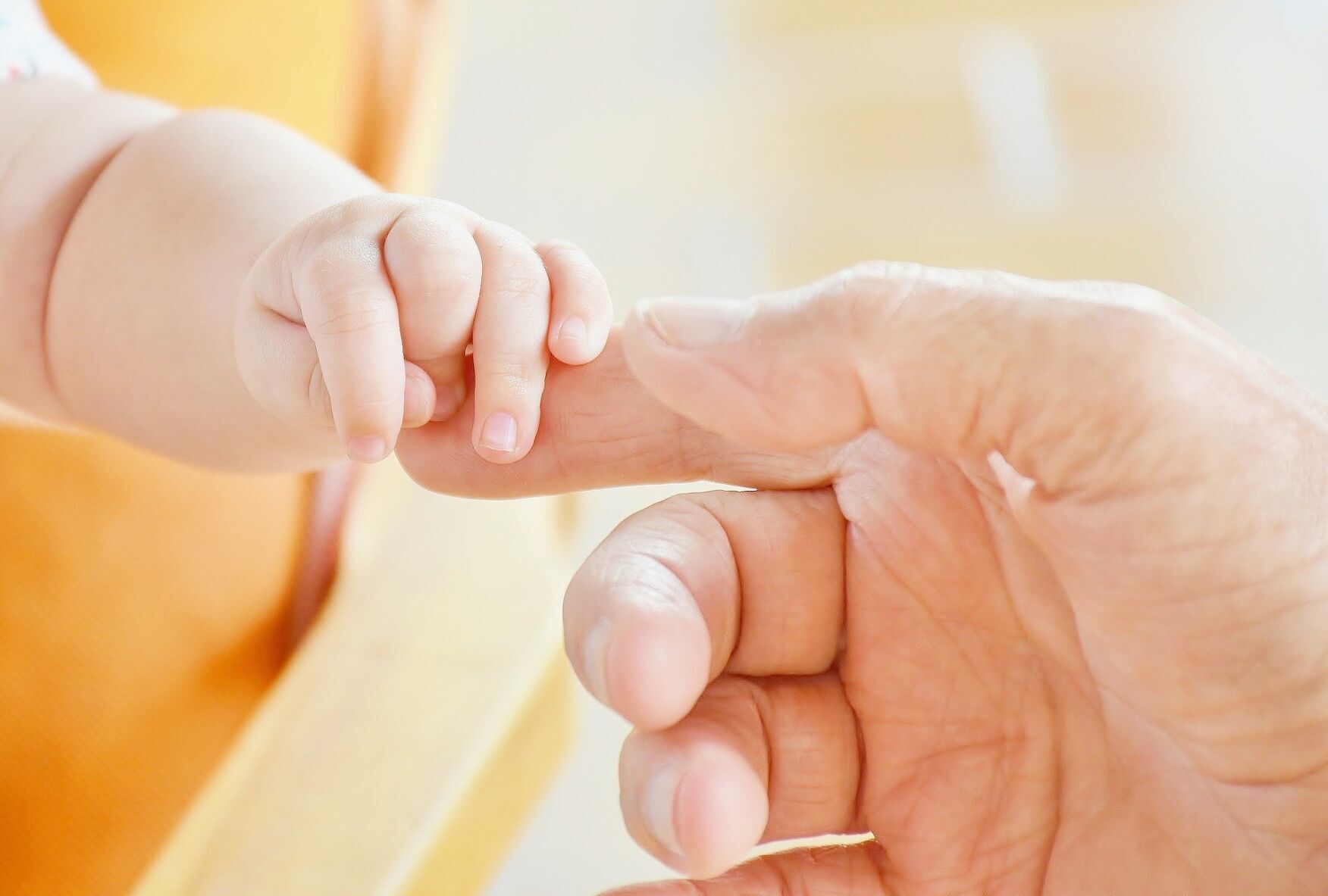 Newborn baby hand on hands